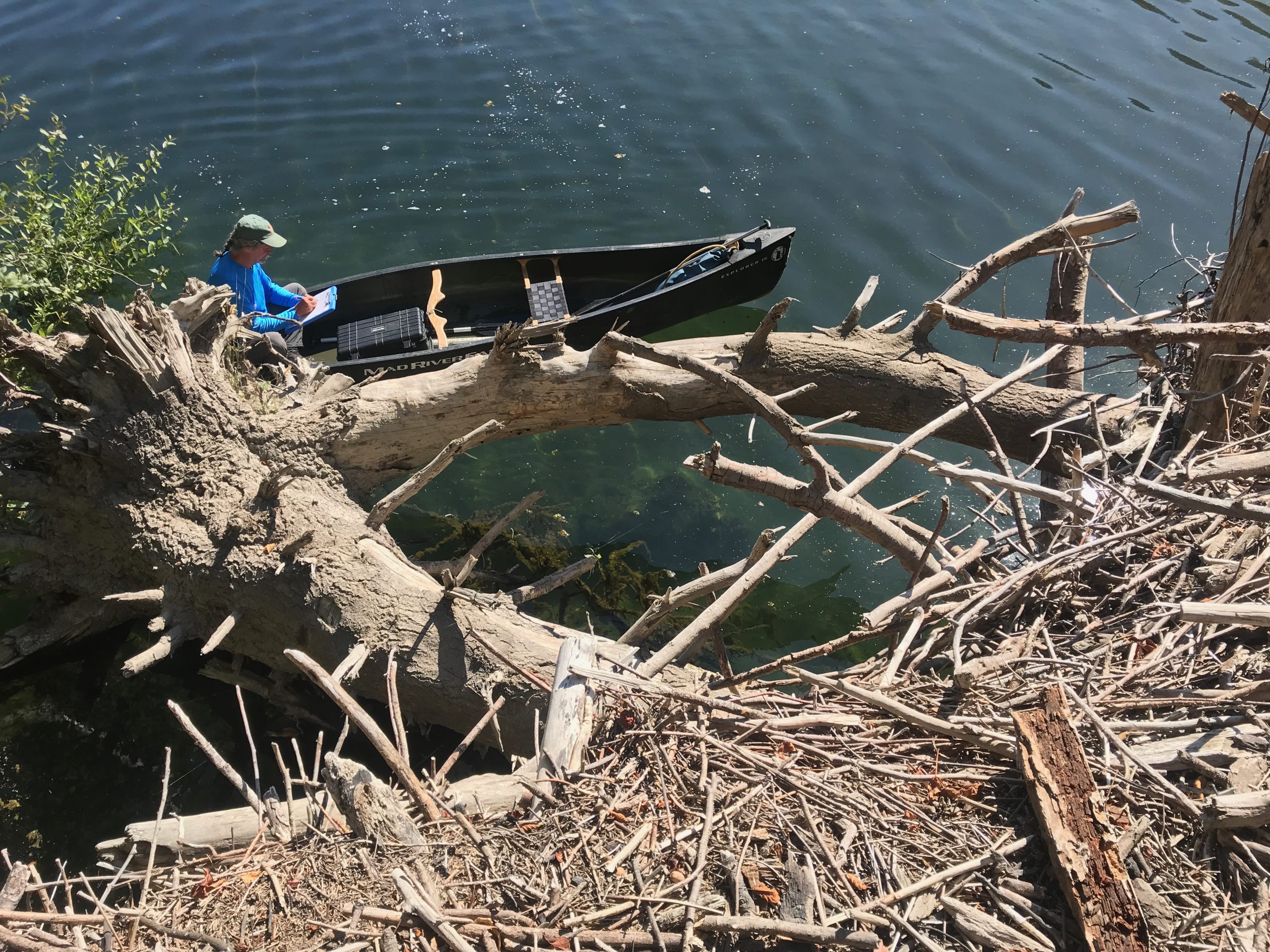 Sungnome in a canoe documenting bathymetric survey data